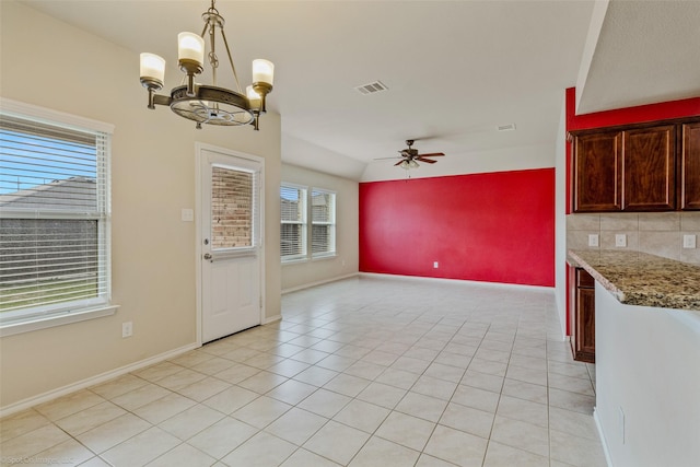 1056 Decker Dr, Fate, TX 75189 - unfurnished dining area featuring light tile patterned flooring, ceiling fan with notable chandelier, visible vents, and baseboards