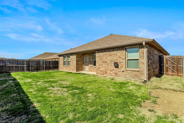1056 Decker Dr, Fate, TX 75189 - back of property featuring a fenced backyard, brick siding, and a lawn