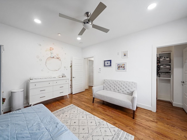 bedroom featuring baseboards, wood finished floors, recessed lighting, and ceiling fan