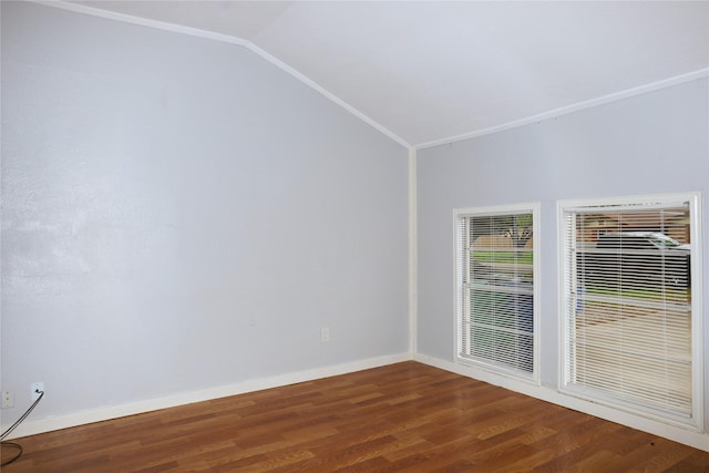 spare room with wood finished floors, lofted ceiling, and baseboards