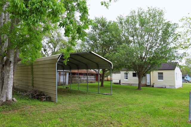 view of yard featuring a detached carport and fence