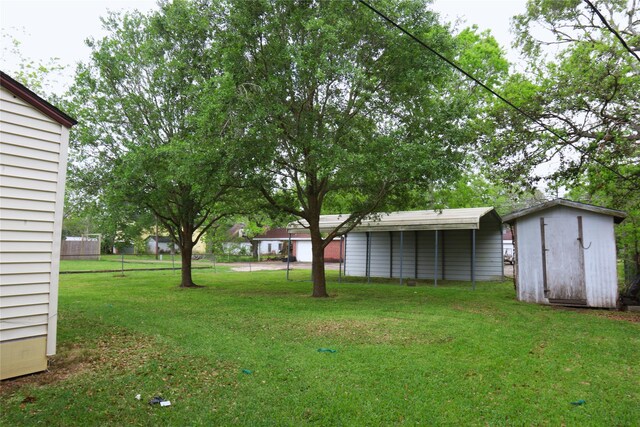 617 Hurst St, Angleton, TX 77515 - view of yard with a storage unit, fence, and an outdoor structure