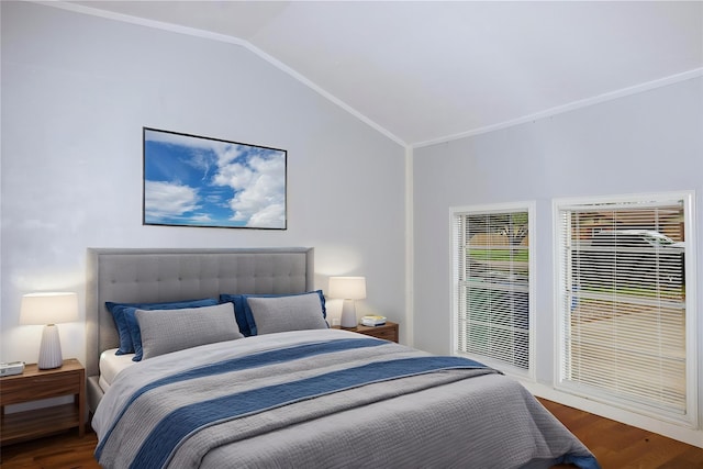 bedroom featuring ornamental molding, vaulted ceiling, and wood finished floors