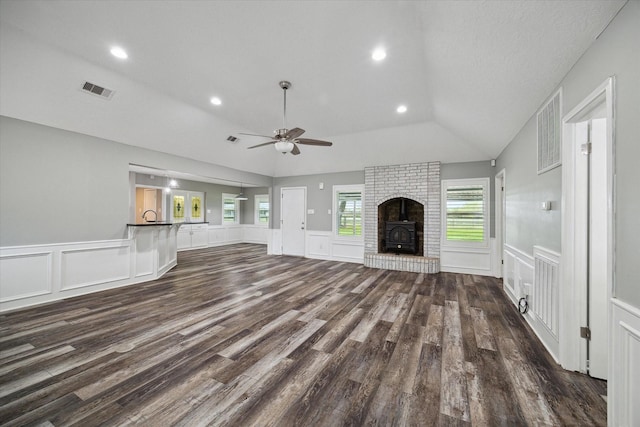 1613 Willow View St, La Porte, TX 77571 - unfurnished living room featuring a decorative wall, vaulted ceiling, a ceiling fan, dark wood-style floors, and healthy amount of natural light