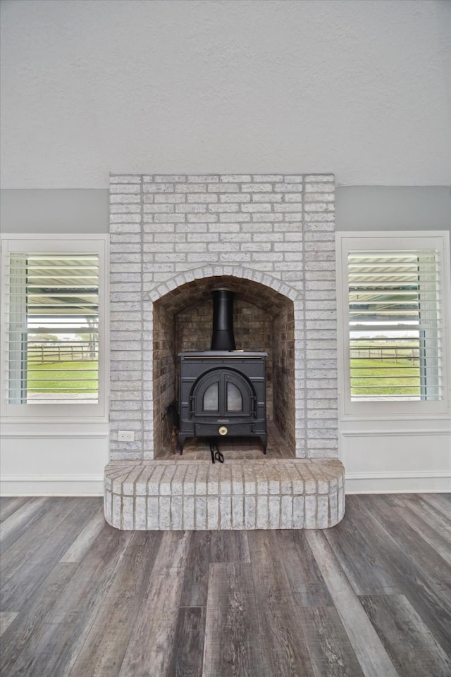 1613 Willow View St, La Porte, TX 77571 - detailed view of a wood stove, wood finished floors, and baseboards