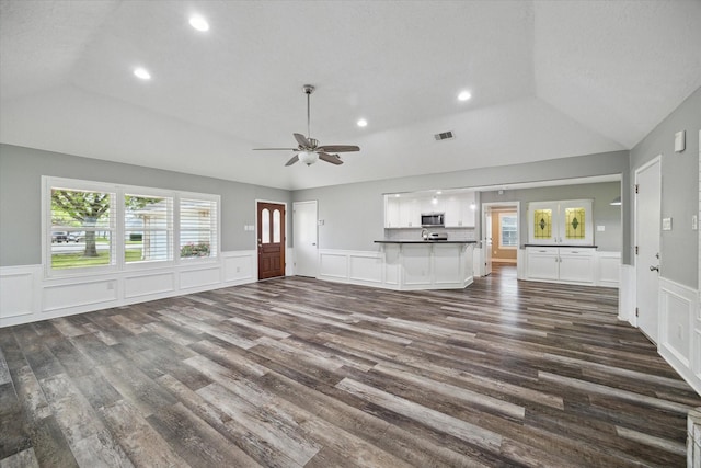 1613 Willow View St, La Porte, TX 77571 - unfurnished living room featuring vaulted ceiling, dark wood-type flooring, a decorative wall, ceiling fan, and recessed lighting