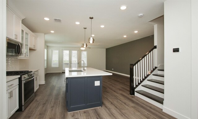 305 E 40th St Unit B, Houston, TX 77018 - kitchen featuring ceiling fan, white cabinets, appliances with stainless steel finishes, dark wood-style flooring, and a sink