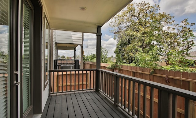 wooden terrace featuring fence