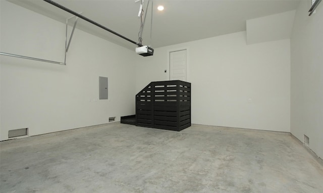 garage featuring a garage door opener and electric panel