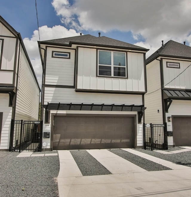 view of front facade featuring a garage, board and batten siding, fence, and concrete driveway