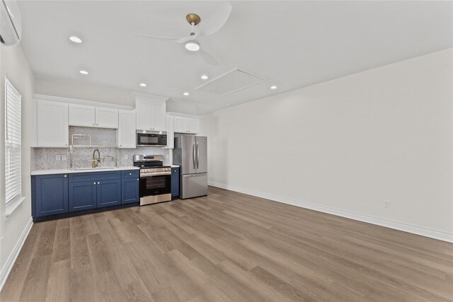 3513 Ursuline St, Galveston, TX 77550 - kitchen featuring light countertops, stainless steel appliances, blue cabinets, decorative backsplash, and ceiling fan