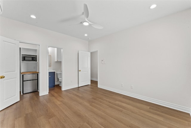3513 Ursuline St, Galveston, TX 77550 - unfurnished bedroom with recessed lighting, ensuite bathroom, baseboards, and wood finished floors