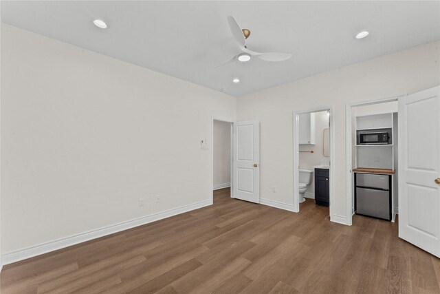3513 Ursuline St, Galveston, TX 77550 - unfurnished bedroom featuring recessed lighting, ensuite bathroom, baseboards, and wood finished floors