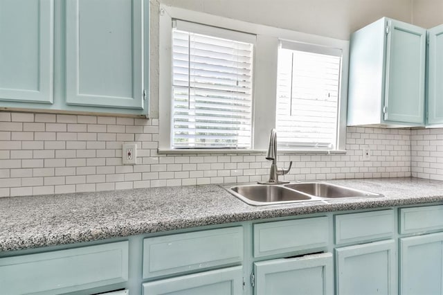6657 Stearns St, Houston, TX 77021 - kitchen with light countertops, tasteful backsplash, a sink, and blue cabinetry