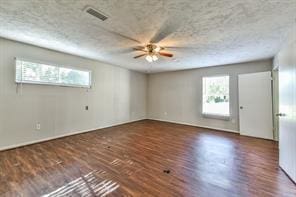 6657 Stearns St, Houston, TX 77021 - empty room with wood finished floors, ceiling fan, visible vents, and a wealth of natural light