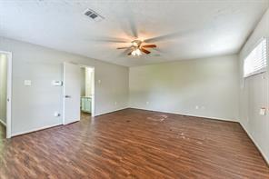 6657 Stearns St, Houston, TX 77021 - empty room featuring wood finished floors, ceiling fan, and visible vents