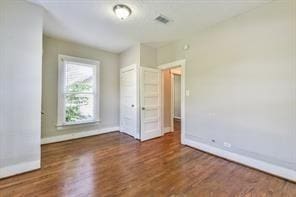 6657 Stearns St, Houston, TX 77021 - unfurnished bedroom featuring visible vents, baseboards, and wood finished floors
