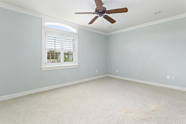 unfurnished room featuring baseboards, ornamental molding, ceiling fan, and carpet flooring