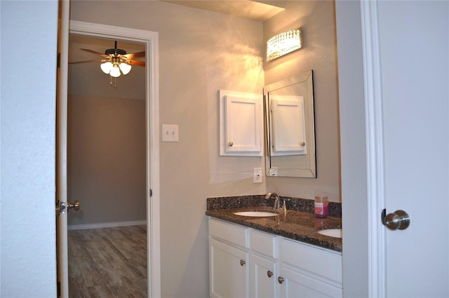 1531 Dan Cox Ave, Katy, TX 77493 - bathroom with double vanity, wood finished floors, a sink, baseboards, and ceiling fan