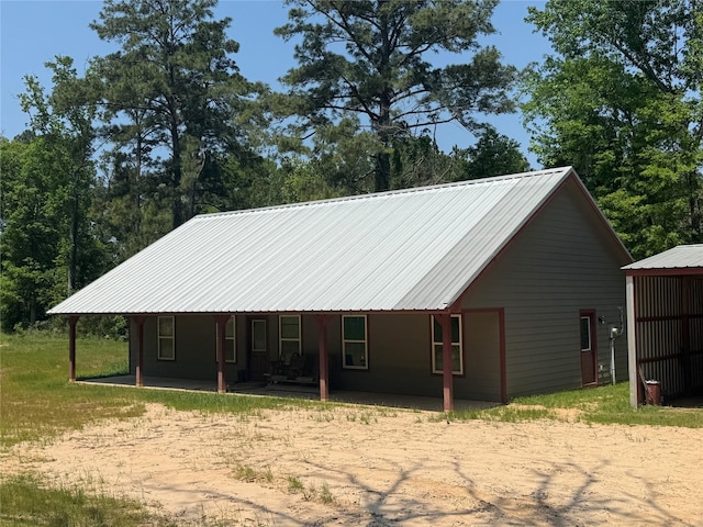 rear view of property with metal roof