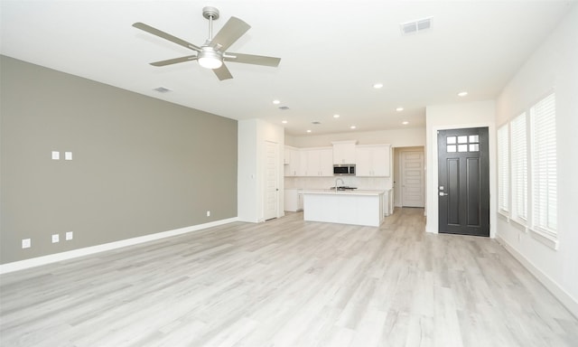 119 E 43rd St Unit A, Houston, TX 77018 - unfurnished living room featuring recessed lighting, light wood finished floors, visible vents, and baseboards