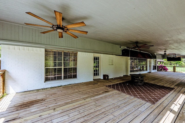 wooden terrace featuring a ceiling fan