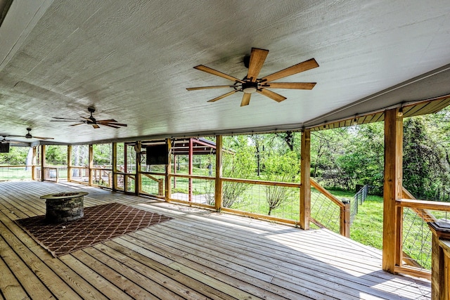 unfurnished sunroom featuring a ceiling fan