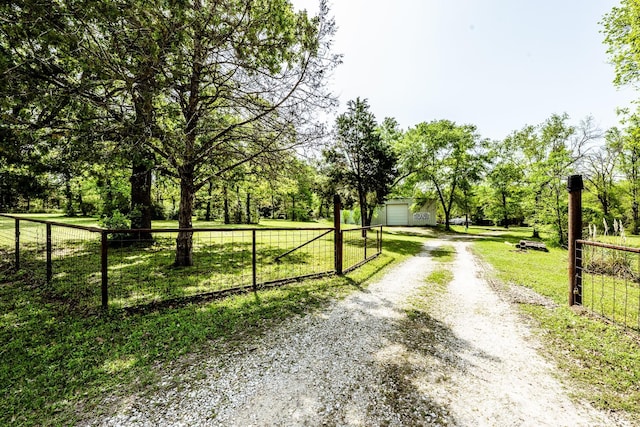 view of street with driveway and a gated entry