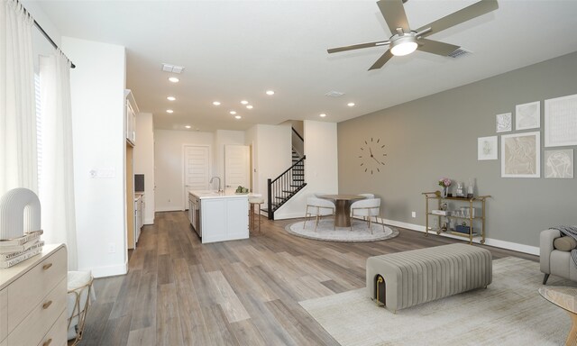 121 E 43rd St Unit B, Houston, TX 77018 - living area with light wood-style floors, a ceiling fan, visible vents, and stairway
