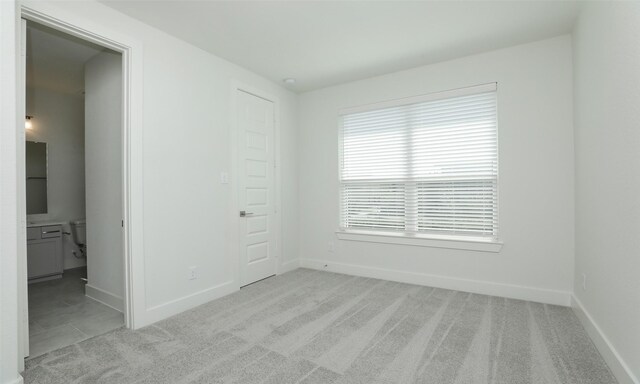 121 E 43rd St Unit B, Houston, TX 77018 - unfurnished room featuring light carpet and baseboards