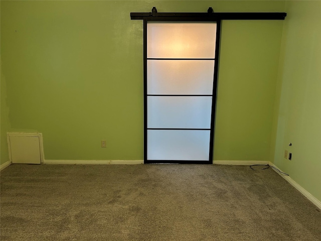 empty room featuring baseboards and carpet flooring