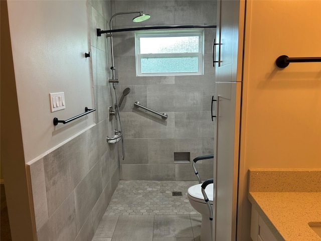 bathroom with toilet, vanity, and a stall shower