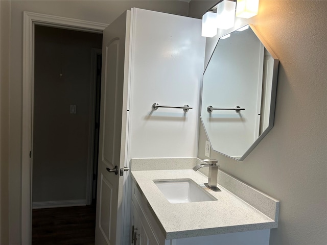bathroom featuring wood finished floors and vanity