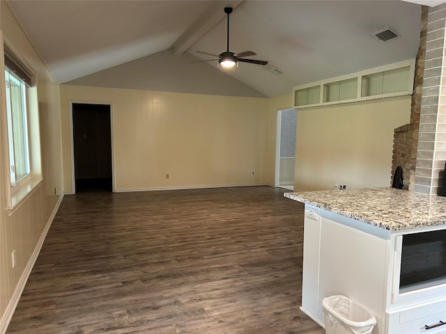 unfurnished living room featuring dark wood-type flooring, ceiling fan, lofted ceiling with beams, and baseboards