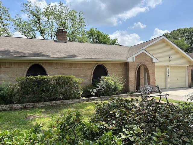 ranch-style home with brick siding, driveway, and an attached garage