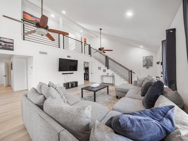 8007 Beluche Dr, Galveston, TX 77551 - living area featuring light wood-style floors, stairway, visible vents, and ceiling fan