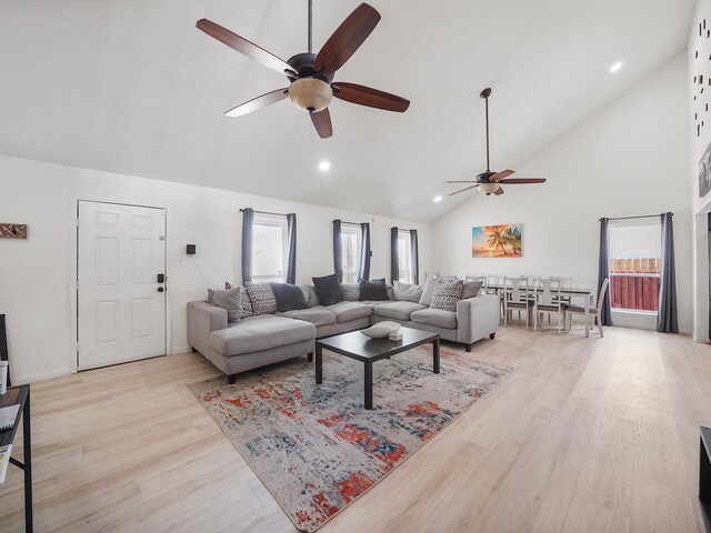 8007 Beluche Dr, Galveston, TX 77551 - living room featuring ceiling fan, high vaulted ceiling, light wood finished floors, and a wealth of natural light