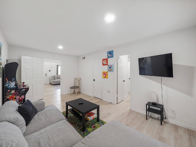 8007 Beluche Dr, Galveston, TX 77551 - living area featuring baseboards, light wood-style floors, and recessed lighting
