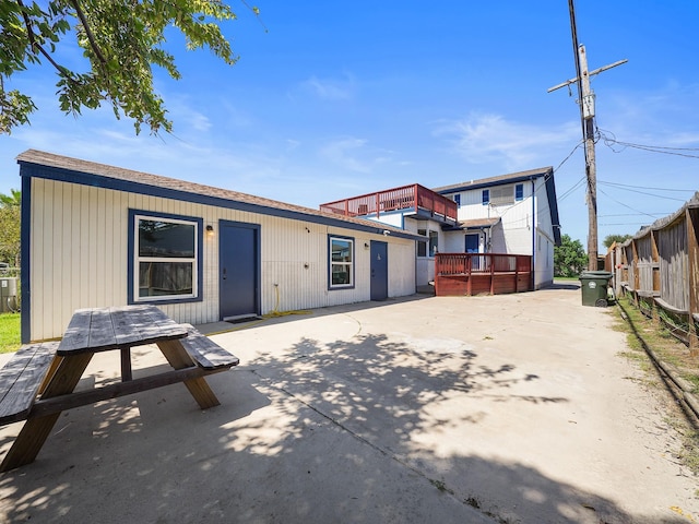 8007 Beluche Dr, Galveston, TX 77551 - back of property with outdoor dining area, fence, and a patio area