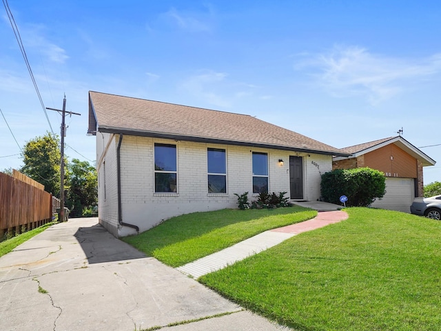 8007 Beluche Dr, Galveston, TX 77551 - view of front of house featuring fence, a garage, a front yard, brick siding, and a shingled roof