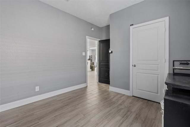 7529 Topaz Way, Texas City, TX 77591 - bedroom with baseboards and light wood-type flooring