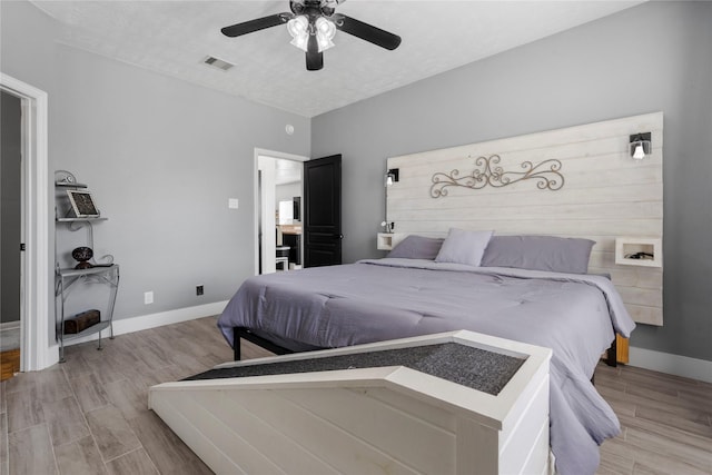 7529 Topaz Way, Texas City, TX 77591 - bedroom featuring baseboards, a textured ceiling, ceiling fan, light wood-style flooring, and visible vents