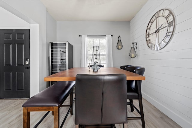 7529 Topaz Way, Texas City, TX 77591 - dining room with wooden walls, baseboards, light wood-style floors, and beverage cooler