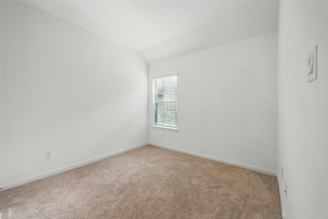 unfurnished room with light carpet, baseboards, and lofted ceiling