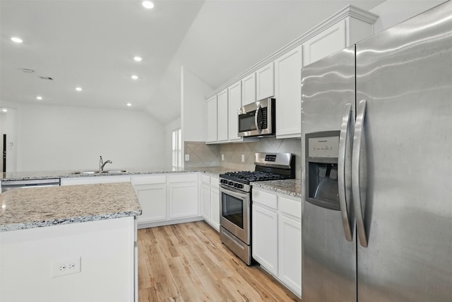 kitchen with light wood finished floors, a sink, white cabinets, and appliances with stainless steel finishes
