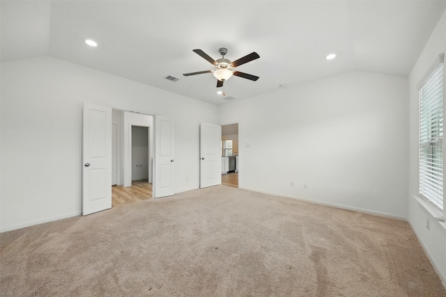 unfurnished bedroom with baseboards, lofted ceiling, recessed lighting, and light carpet