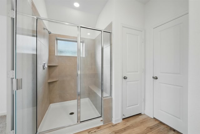 full bathroom featuring a shower stall, wood finished floors, and recessed lighting