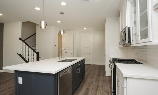 910 W 21st St Unit B, Houston, TX 77008 - kitchen featuring tasteful backsplash, white cabinets, appliances with stainless steel finishes, dark wood-style flooring, and a sink