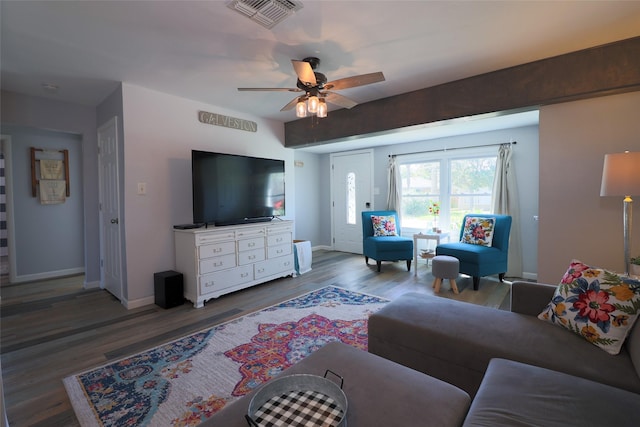 living room featuring wood finished floors, baseboards, ceiling fan, and visible vents