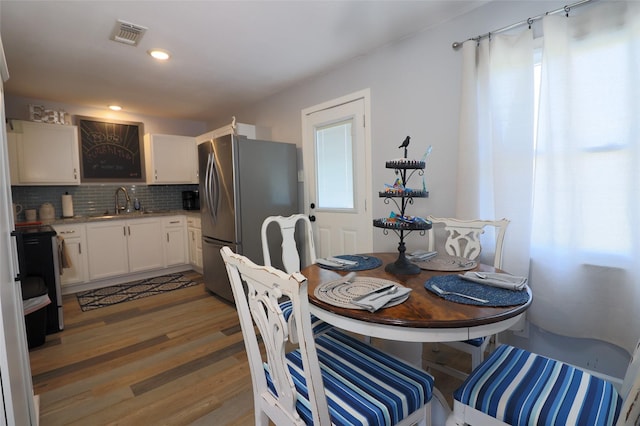 dining room with visible vents, recessed lighting, and light wood finished floors